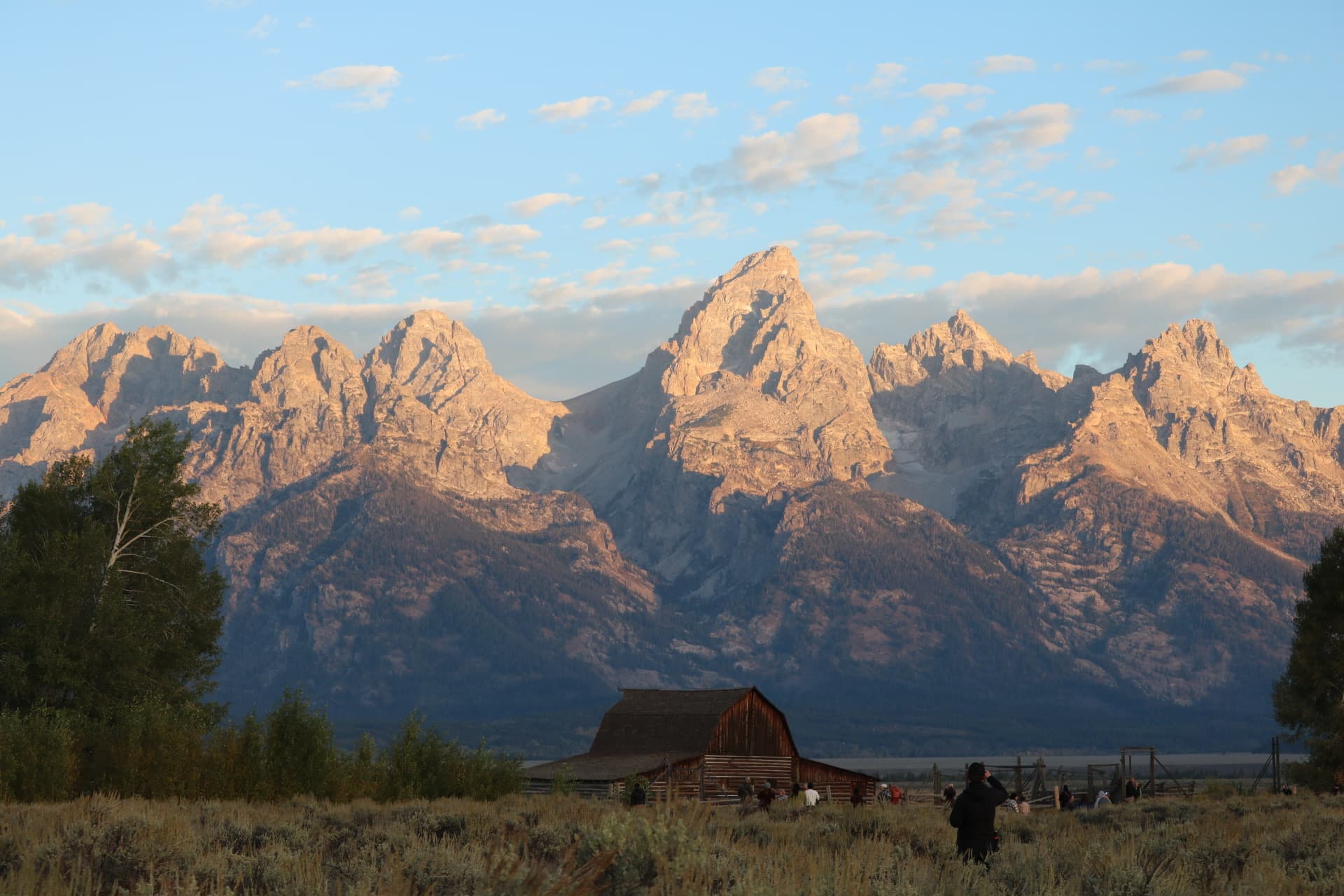 Sunset glow on the peaks above the Mormon Row barn